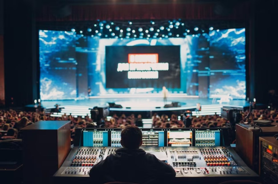 back view of a lighting technician or a sound engineer managing a concert event